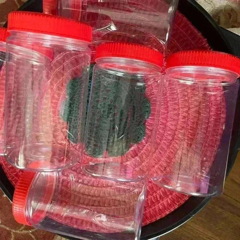 Set of 6 plastic containers clear with red lid 6.5 in height 11.5 width of jar